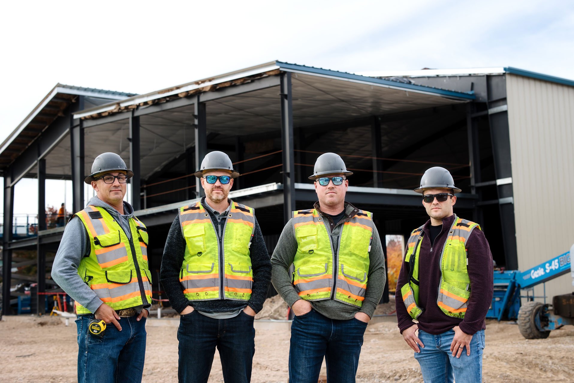 Hall & Hill Construction crew reviewing plans on an active commercial job site